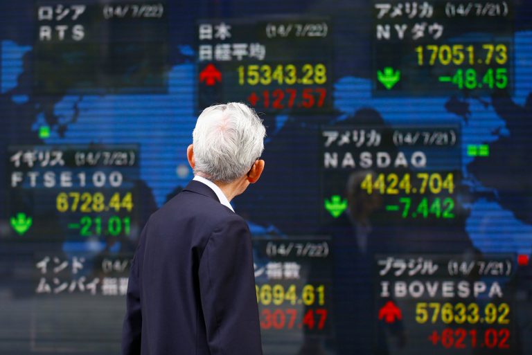 A man watches an electronic stock indicator in Tokyo, Tuesday, July 22, 2014. Asian shares rose Tuesday as tensions over the downing of a passenger jet in Ukraine eased after pro-Moscow separatists released a train packed with bodies and handed over the aircraft's black boxes. Japan's Nikkei 225 stock index added 0.8 percent to 15,343.28 as trading resumed after Monday's public holiday. (AP Photo/Shizuo Kambayashi)