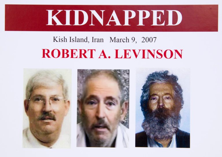 An FBI poster shows several images of former agent Robert Levinson, including a display of how he would look after five years in captivity, during a news conference in Washington in March 2012. (AP Photo/Manuel Balce Ceneta)