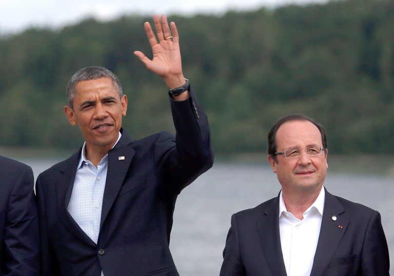 FILE - In this June 18, 2013 file photo, President Barack Obama, accompanied by French President Francois Hollande waves during a group photo opportunity at the G-8 summit at the Lough Erne golf resort in Enniskillen, Northern Ireland. President Barack Obama says Hollande will make a state visit to the U.S. in February. Obama says in a statement that the U.S. and France are close friends and allies, including through NATO, and have worked in tandem for more than 200 years to support democracy, liberty and freedom at home. (AP Photo/Lefteris Pitarakis, File)