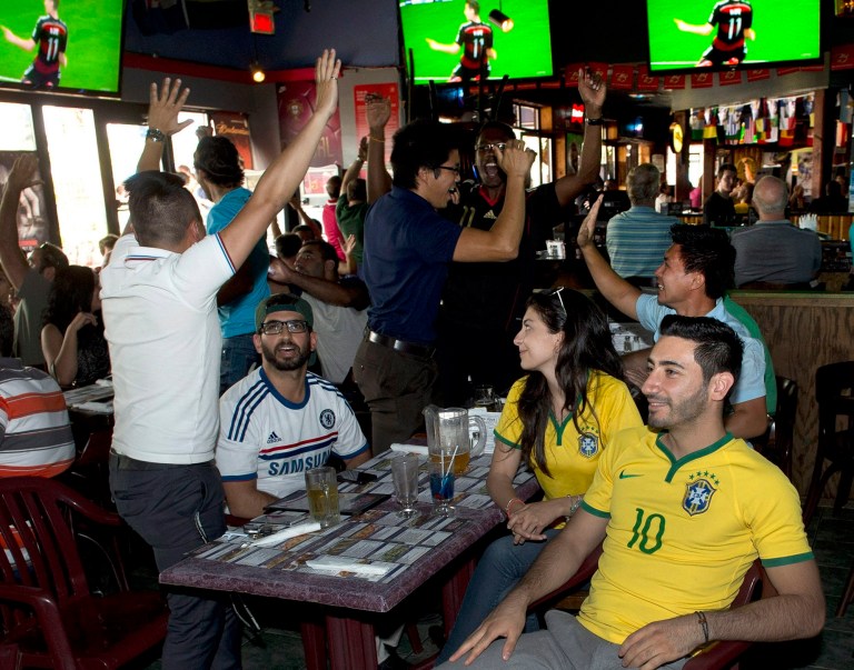 Fans react after the second German goal as they watch the Germany-Brazil World Cup soccer semi-final at PJ's Pub on July 8, 2014 in Montreal.  Canada has not sent a team to the World Cup in a generation. But that hasn't stopped Canadians from going a little Cup crazy. FIFA organizers say Canadians bought more than 29,000 tickets to World Cup matches, outranking all other nations that didn't qualify for the Cup and behind only 10 nations that did. (AP Photo/The Canadian Press, Ryan Remiorz)