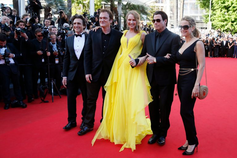 From right, Kelly Preston, John Travolta, Uma Thurman, director Quentin Tarantino and producer Laurence Bender arrive for the screening of Sils Maria at the 67th international film festival, Cannes, southern France, Friday, May 23, 2014. (AP Photo/Alastair Grant)