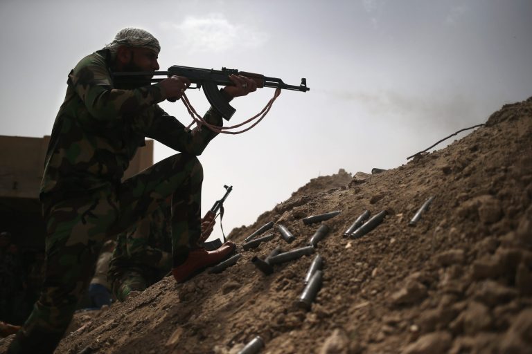 A volunteer from the Badr Brigade militia fires on ISIS fighters from the frontline on April 11, 2015 in Ebrahim Ben Ali, in Anbar Province, Iraq. (Getty Image)