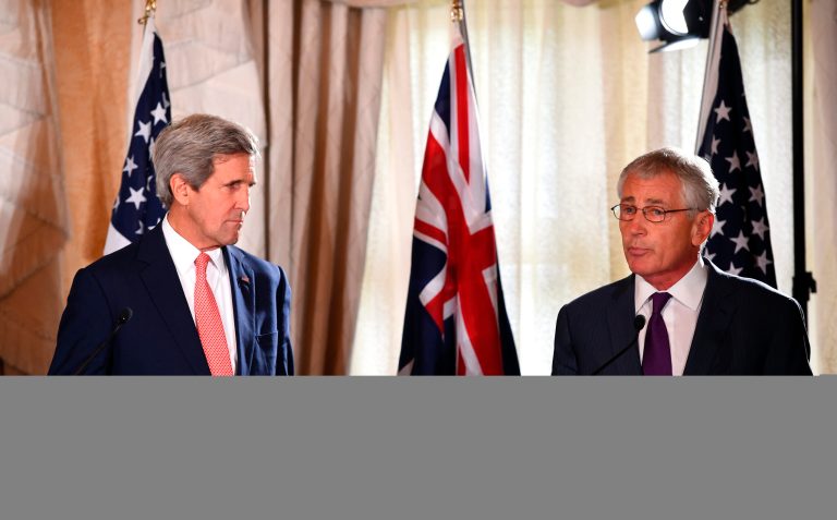 Obama sends his national security team as envoys; Secretary of State Kerry (left) and Defense Secretary Hagel often travel the world on the president's behalf. (Getty images/Dan Himbrechts)