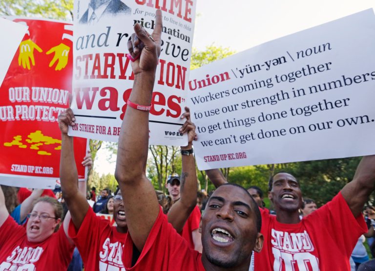 Protesters gather outside of the McDonald's Corporation headquarters in Oak Brook, Ill., during the annual shareholders meeting demonstrating for higher wages and the right to unionize, in this May 22, 2014 file photo. (AP Photo/M. Spencer Green, File)