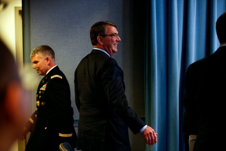 Defense Secretary Ash Carter, center, departs following a news conference at the Pentagon, Thursday, April 16, 2015. (AP Photo/Andrew Harnik)