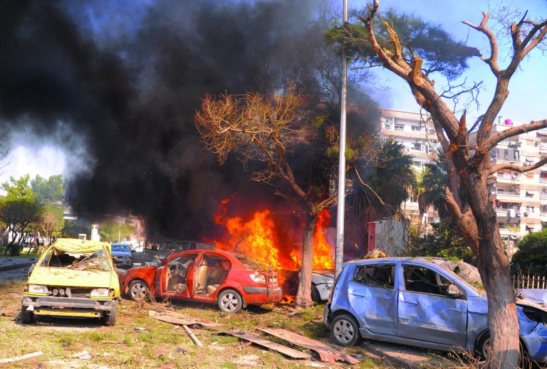 This photo released by the Syrian official news agency SANA, shows flames and smoke rising from burned cars after a huge explosion that shook central Damascus, Syria, Thursday, Feb. 21, 2013. A car bomb shook central Damascus on Thursday, exploding near the headquarters of the ruling Baath party and the Russian Embassy, eyewitnesses and opposition activists said. (AP Photo/SANA)