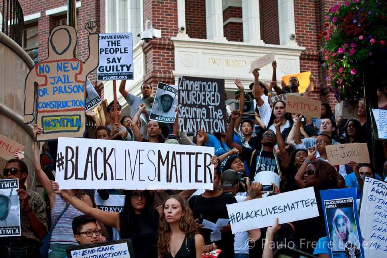 Black Lives Matter protesters gather with signs (via Facebook).