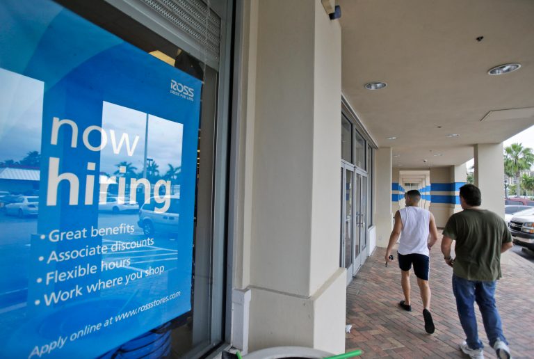 FILE - In this May 16, 2014 file photo, shoppers walk past a now hiring sign at a Ross store in North Miami Beach, Fla. The Labor Department releases weekly jobless claims on Thursday, June 12, 2014. (AP Photo/Wilfredo Lee, File)