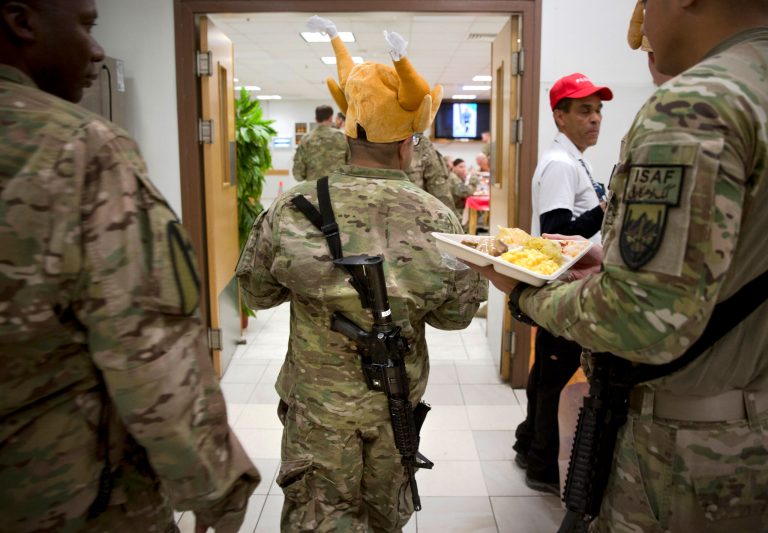 A U.S. soldier wears a hat in the shape of a turkey as he has his Thanksgiving dinner at his base in Kabul, Afghanistan, Thursday, Nov. 28, 2013. It's the 12th Thanksgiving in Afghanistan for U.S. troops. (AP Photo/Anja Niedringhaus)