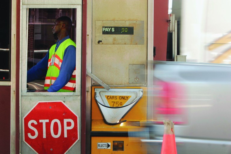 A toll booth collector works at the main toll plaza on the Dulles Toll Road in Northern Virginia on April 19, 2006. Original: Andrew Harnik/Examiner
