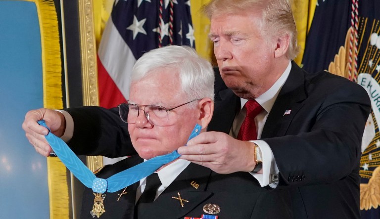 President Donald Trump bestows the nation's highest military honor, the Medal of Honor, to retired Army Capt. Gary M. Rose, during a ceremony in the East Room of the White House in Washington, Monday, Oct. 23, 2017. (AP Photo/Pablo Martinez Monsivais)
