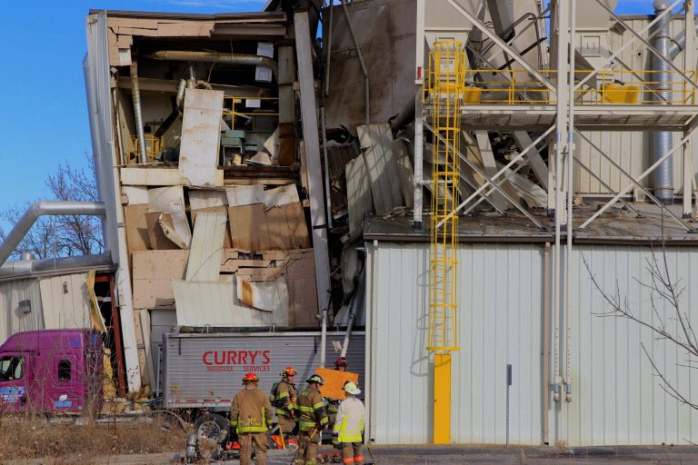 FILE - In this Jan. 20, 2014 file photo firefighters stage outside the International Nutrition animal feed processing plant in Omaha, Neb. Federal investigators said Monday July 21, 2014 overloaded storage bins on the roof of the plant caused the building collapse that killed two people. (AP Photo/Nati Harnik, File)