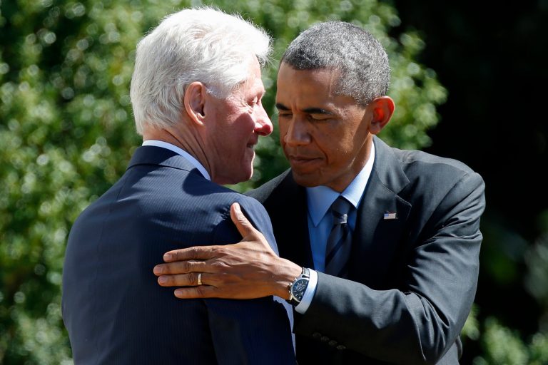President Barack Obama embraces former President Bill Clinton on the South Lawn of the White House in Washington, Friday, Sept. 12, 2014, after Clinton spoke at an event marking the 20th anniversary of AmeriCorps, which promotes volunteerism and community service. President Barack Obama and former President Bill Clinton joined forces Friday to mark the 20th anniversary of the AmeriCorps national service program, heralding the impact volunteering can have on both individuals and the nation.  (AP Photo/Charles Dharapak)