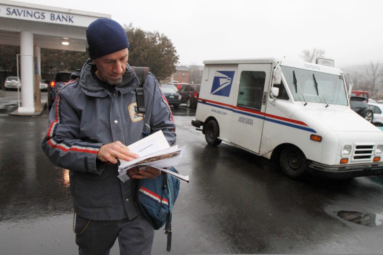 A Postal Service mail carrier makes deliveries in Montpelier, Vt., in December 2011. (AP Photo/Toby Talbot)