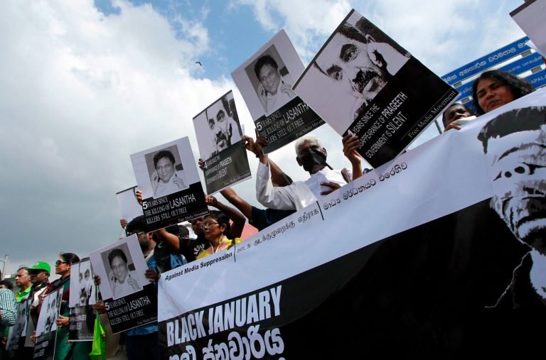 Members of the media and their supporters hold placards, carrying portraits of killed and abducted journalists, during a protest in Colombo, Sri Lanka, Tuesday, Jan. 28, 2014.  Thousands of protesters from opposition parties, rights and media activist groups rallied against the Sri Lankan government in a rare show of dissent, accusing the authorities of mismanagement, corruption and a breakdown of law and order. (AP Photo/Eranga Jayawardena)