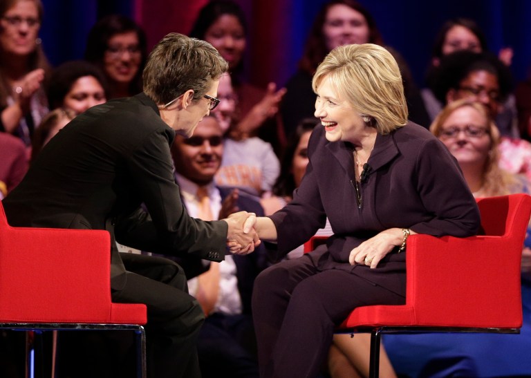 Democratic presidential candidate, Hillary Rodham Clinton, right, shakes hands with MSNBC's Rachel Maddow, left, during a democratic presidential candidate forum at Winthrop University in Rock Hill, S.C., Friday, Nov. 6, 2015. Her show and several others on MSNBC and CNN are being targeted by the nation's top conservative media critic. (AP Photo/Chuck Burton)