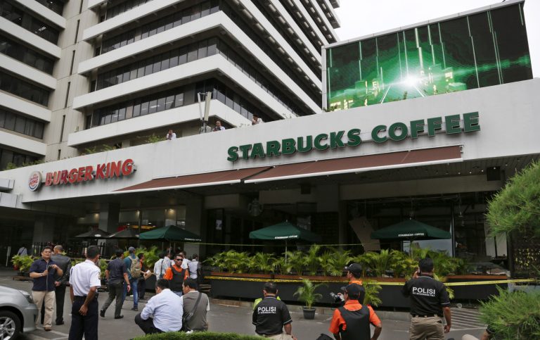 Attackers set off explosions at the cafe in a bustling shopping area in Indonesia's capital and waged gunbattles with police Thursday. (AP Photo/Achmad Ibrahim)