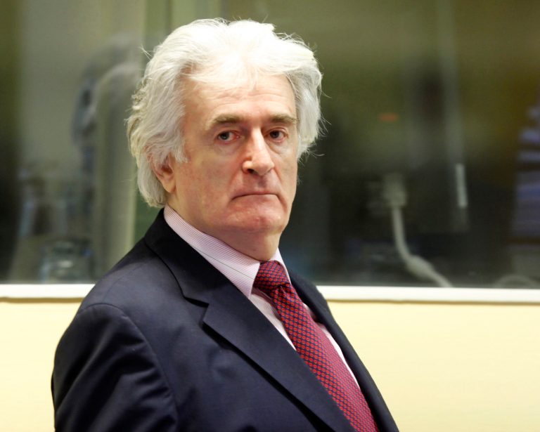   FILE - In this Nov. 3, 2009 file photo former Bosnian Serb leader Radovan Karadzic enters the courtroom of the U.N.'s Yugoslav war crimes tribunal in The Hague, Netherlands. Karadzic, 66, asked U.N. judges on Monday, June 11, 2012, to dismiss his war crimes case halfway through the trial. Prosecutors finished presenting evidence against Karadzic last month, and he is calling for dismissal of all or some charges before he presents his formal defense. (AP Photo/Michael Kooren/Pool, File)  