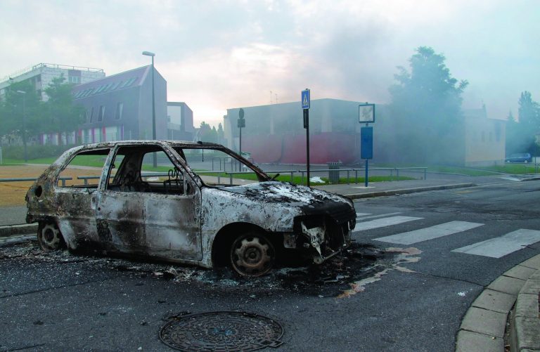 The shell of a burnt out car is seen in a neighborhood of Amiens, France, Tuesday, Aug. 14, 2012. Dozens of young men rioted in a troubled district in northern France after weeks of tensions, pulling drivers from their cars and stealing the vehicles, and burning a school and a youth center. The police department in Amiens says at least 16 officers were hurt by the time the riot ended Tuesday, some by buckshot. (AP Photo/Georges Charrieres)