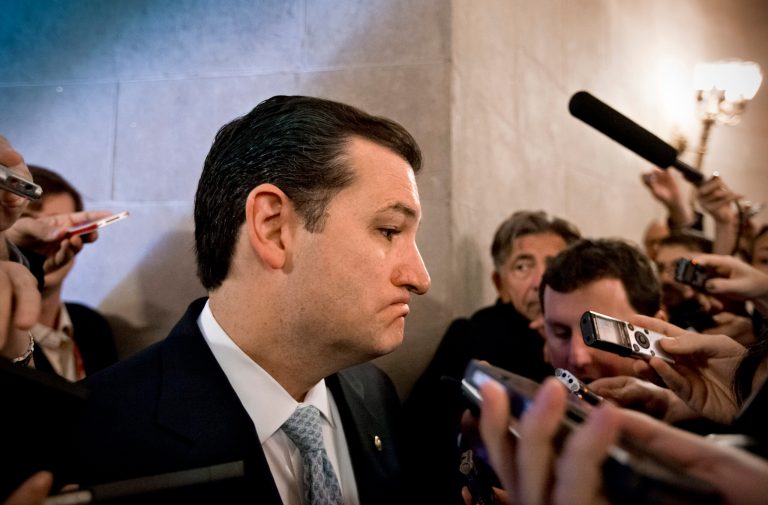 Sen. Ted Cruz, R-Texas, speaks to reporters waiting outside a closed-door meeting of Senate Republicans as news emerged that leaders reached a last-minute agreement to avert a threatened Treasury default and reopen the government after a partial, 16-day shutdown, at the Capitol in Washington, Wednesday, Oct. 16, 2013. Cruz said he would not try to block the agreement.   (AP Photo/J. Scott Applewhite)