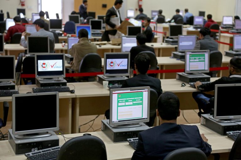 Afghan election workers count votes at the the Independent Election Commission in Kabul, Afghanistan, Sunday, April 20, 2014. New partial results in Afghanistan's presidential election released Sunday show candidate Abdullah Abdullah is still the front-runner, though a runoff election looks likely. (AP Photo/Rahmat Gul)