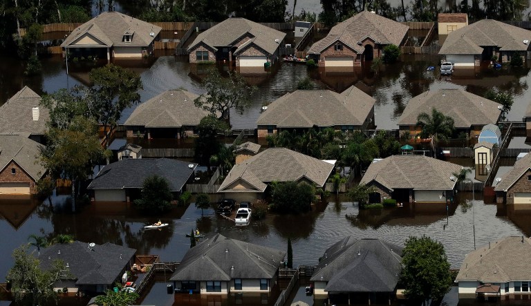 One reason why Hurricanes Harvey and Irma caused so much damage is that people keep building and rebuilding in areas where floods are likely. They keep doing it, Matt Welch noted this week in the Los Angeles Times, because they are often being subsidized by the federal National Flood Insurance Program. (AP Photo/Charlie Riedel)