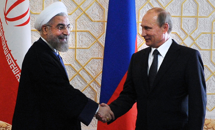 Russian President Vladimir Putin, right, and Iranian President Hassan Rouhani shake hands as they meet at the Shanghai Cooperation Organization summit in Dushanbe, Tajikistan, Friday, Sept. 12, 2014. (AP Photo/RIA Novosti, Mikhail Klimentyev, Presidential Press Service)