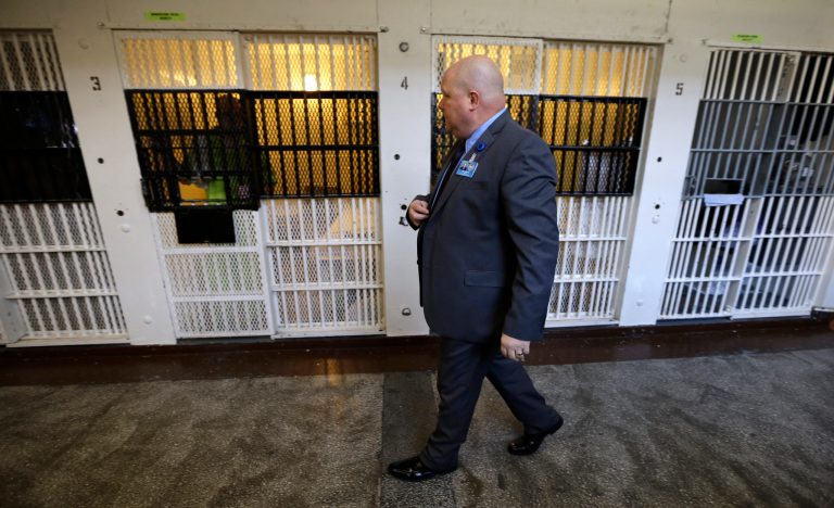 In this Nov. 18, 2013 photo, warden Nick Ludwick walks past a row of cells at the Iowa State Penitentiary in Fort Madison, Iowa. (AP Photo)Â 