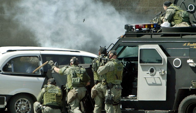 Sending cops into neighborhoods strapped for battle can create a dangerous use-it-or-lose-it mentality. (AP Photo/Ric Francis, File)