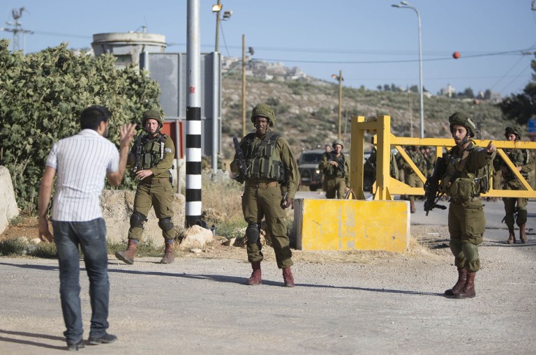 Israel rescinded the entry permits of about 83,000 people, after a Wednesday terrorist attack in Tel Aviv killed four people. (AP Photo/Majdi Mohammed)