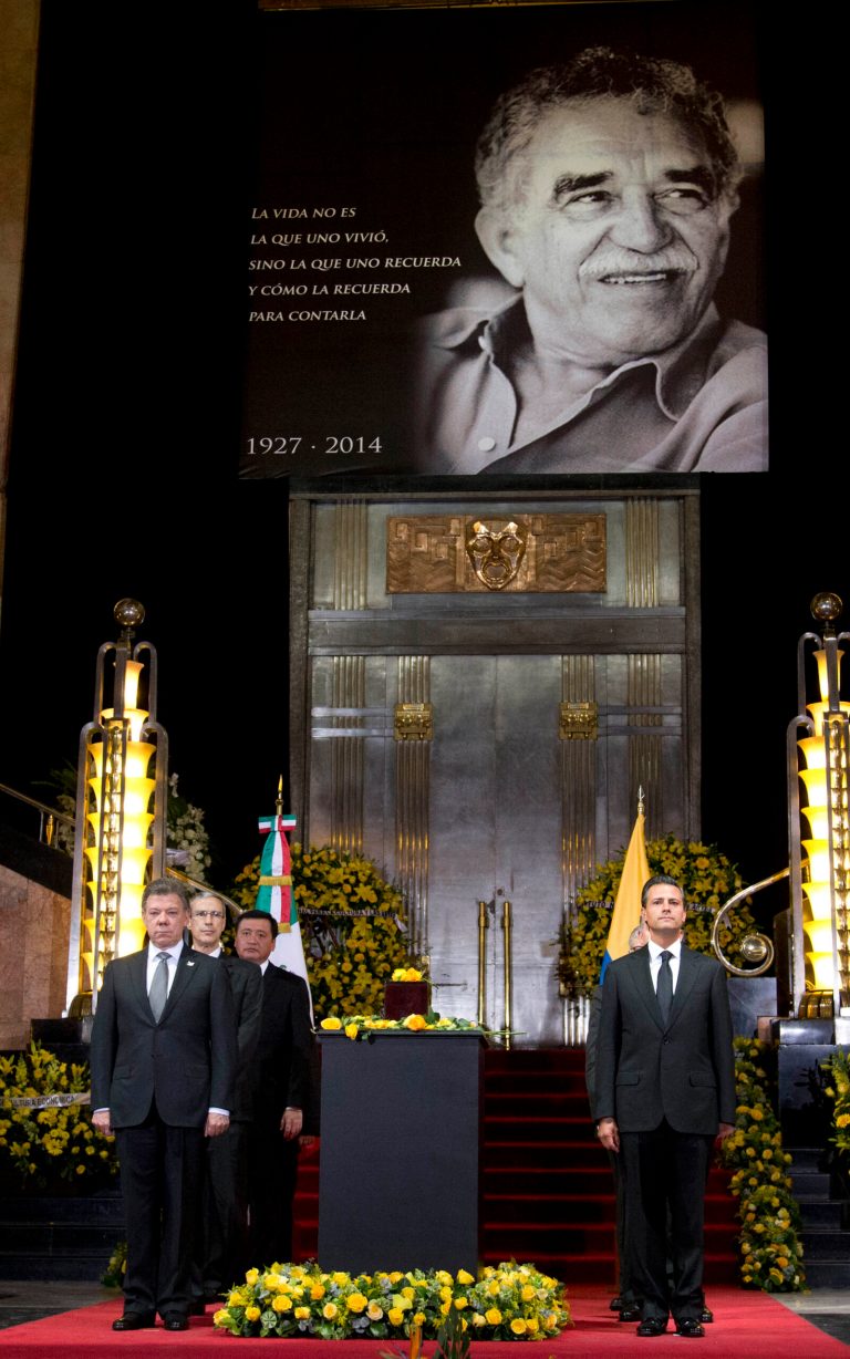 Colombia's President Juan Manuel Santos, left, and Mexico's President Enrique Pena Nieto, stand next to the urn containing the ashes of Colombian Nobel Literature laureate Gabriel Garcia Marquez during the authors homage at the Palace of Fine Arts in Mexico City, Monday, April 21, 2014. Garcia Marquez died on Thursday at his home in Mexico City. His magical realist novels and short stories exposed tens of millions of readers to Latin America's passion, superstition, violence and inequality. (AP Photo/Eduardo Verdugo)