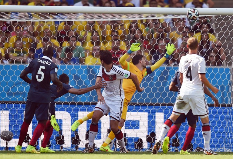 Germany's Mats Hummels, centrer, scores the opening goal during the World Cup quarterfinal soccer match between Germany and France at the Maracana Stadium in Rio de Janeiro, Brazil, Friday, July 4, 2014. (AP Photo/Martin Meissner)