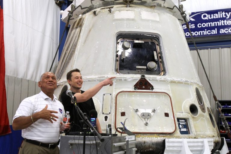   NASA Administrator Charles Bolden, left, and SpaceX CEO Elon Musk, right, answer questions in front of the SpaceX Dragon spacecraft Wednesday June 13, 2012 at the SpaceX Rocket Development Facility in McGregor, Texas. The spacecraft recently made history as the first commercial vehicle to visit the International Space Station. The California-based SpaceX is the first private business to send a cargo ship to the space station. (AP Photo/Waco Tribune-Herald, Duane A. Laverty)  