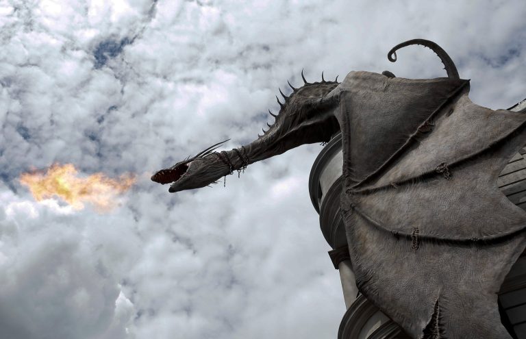 A dragon breathes fire from atop Gringnotts Bank during a preview of Diagon Alley at the Wizarding World of Harry Potter at Universal Orlando, Thursday, June 19, 2014, in Orlando, Fla. (AP Photo/John Raoux)