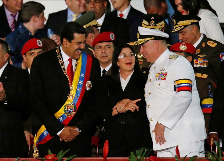 FILE - In this July 5, 2013 file photo, Venezuela's President Nicolas Maduro, left, speaks with Defense Minister Admiral Diego Molero, right, during an Independence Day parade at Fort Tiuna in Caracas, Venezuela, as first lady Cilia Flores stands between them. Peru's government has expelled Molero, Venezuela's current ambassador to Peru, as regional pressure builds on Maduro's government for allegedly trampling on the constitutional order. (AP Photo/Fernando Llano, File)