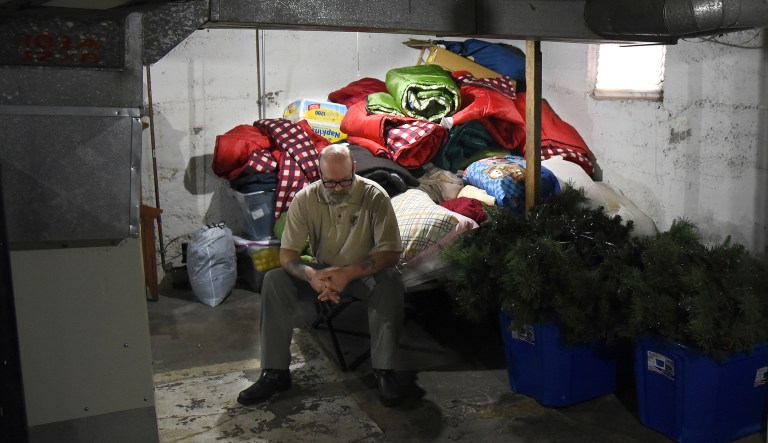 In this Jan. 8, 2018 photo, Greg Schiller is seen in the basement of his home in Elgin, Ill. Schiller, a longtime advocate for the homeless, had been allowing homeless people to sleep in his unfinished basement until the city cited him in late December. After suffering a week of bad publicity, Elgin agreed to make sure no one would be turned away who turned up seeking shelter. (Rick West/Daily Herald, via AP)