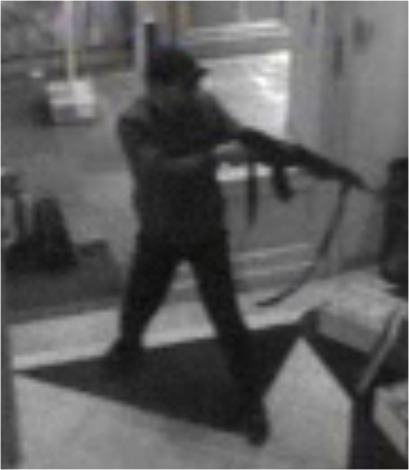 In this hand out photo distributed on Sunday, May 25, 2014 by the Belgian Federal Police, a surveillance camera shows a man shooting at the Jewish museum in Brussels, Belgium, on Saturday, May 24, 2014. Police stepped up security at Jewish institutions, schools and synagogues after three people were killed and one seriously injured in a spree of gunfire at the Jewish Museum in Brussels on Saturday. (AP Photo/Belgian Federal Police)