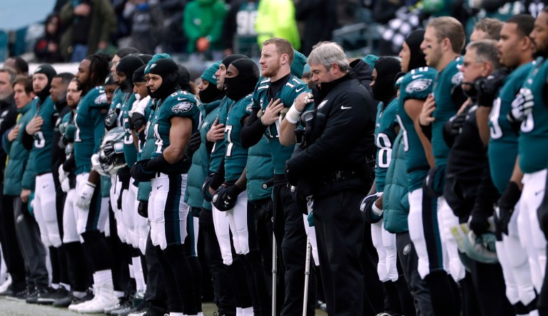 Philadelphia Eagles' Carson Wentz center, listens to the national anthem before an NFL football game against the Dallas Cowboys, Sunday, Dec. 31, 2017, in Philadelphia.