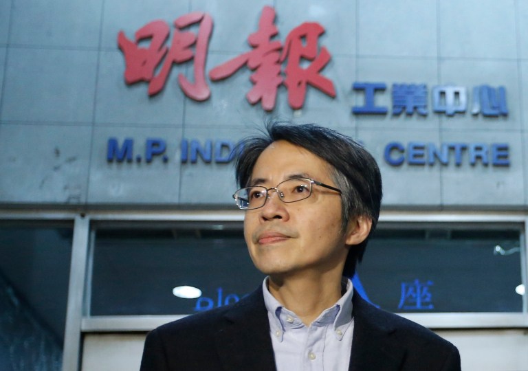in this January 13, 2014 photo, former Ming Pao chief editor Kevin Lau Chun-to is seen outside his office building in Hong Kong. The former editor of a Hong Kong newspaper whose abrupt dismissal in January sparked protests over press freedom has been stabbed, police said on Wednesday. Police said a man wearing a motorcycle helmet âsuddenlyâ attacked Kevin Lau on Wednesday morning with a knife and then fled on a motorcycle driven by another man.  (AP Photo/Str)