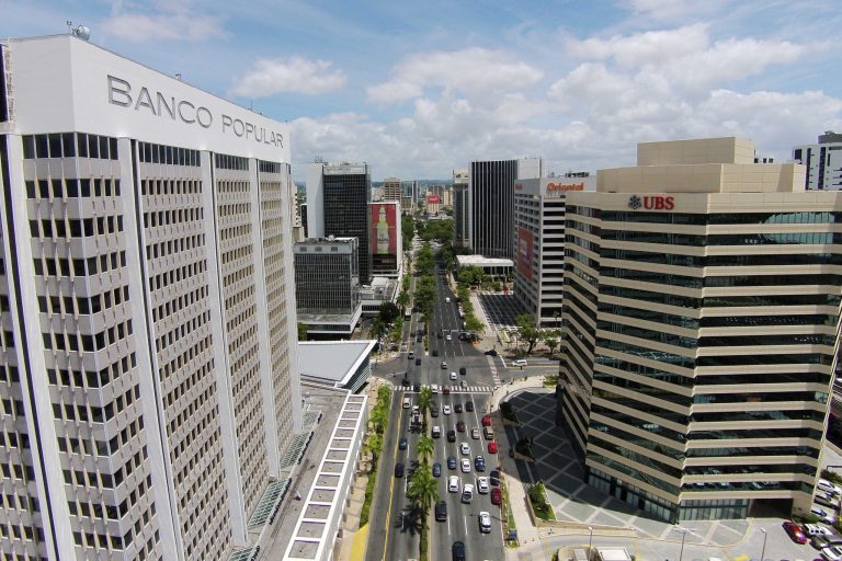This July 16, 2014 photo shows the financial district in San Juan, Puerto Rico. Puerto Rico has seen a flurry of credit rating downgrades since the announcement of a law that allows some public corporations to restructure their debt if needed. The law was approved as the U.S. territory enters its eighth year in recession. (AP Photo/Ricardo Arduengo)