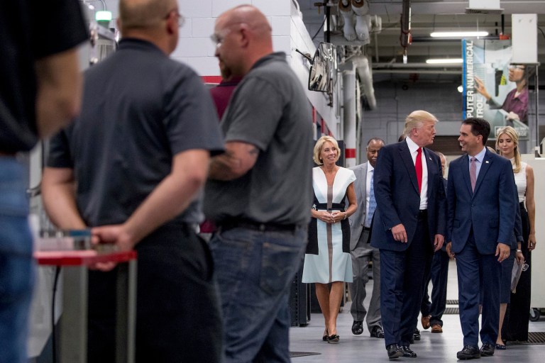 Trump toured a technical college in the suburban Milwaukee county on Tuesday afternoon, outlining his administration's plans to help boost apprenticeship programs and close the skills gap in the labor force. (AP Photo/Andrew Harnik)