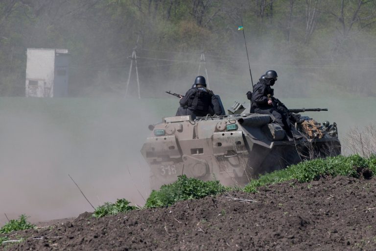 Ukrainian government troops atop of their armored personal carrier rolls on a country road outside the town of Svyitohirsk near to Slovyansk, eastern Ukraine, Saturday, April 26, 2014. Ukrainian authorities are undertaking a security operation to liberate the nearby city of Slovyansk, which is currently controlled by an armed pro-Russian insurgency.(AP Photo/Alexander Zemlianichenko)