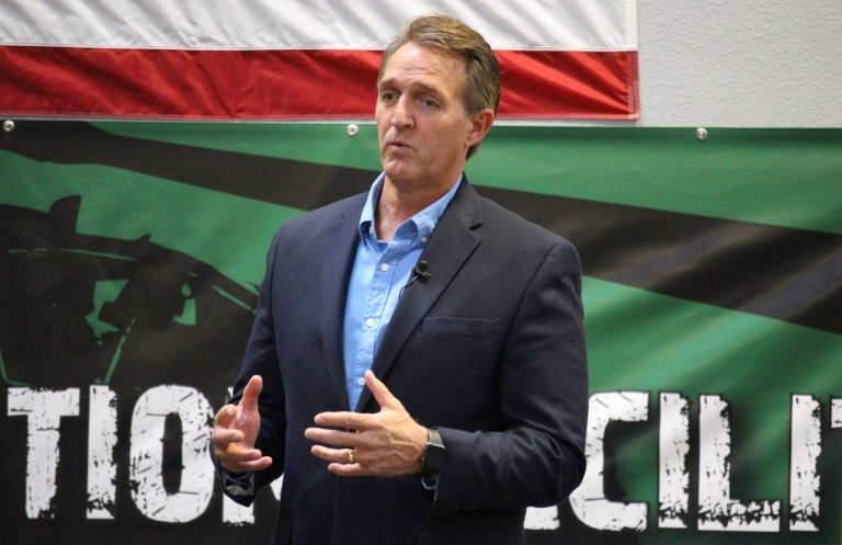 U.S. Sen. Jeff Flake, R-Ariz., speaks to aerospace workers about the current congressional tax reform proposal in Mesa, Ariz., Friday, Nov. 17, 2017. The Republican told aerospace company workers that corporate tax cuts are needed to restore America's global competitiveness. (AP Photo/Bob Christie)