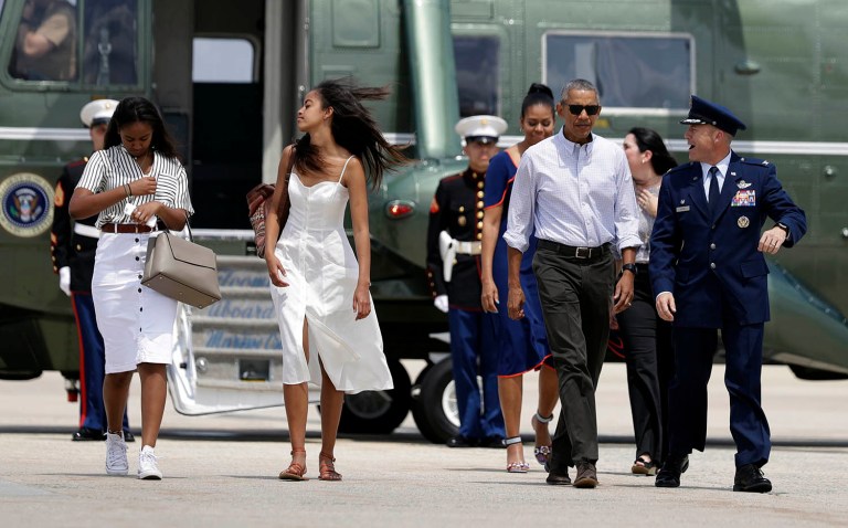 The Obama family walks on the tarmac to board Air Force One at Joint Base Andrews for a family vacation in the Massachusetts island of Martha's Vineyard. (AP Photo/Manuel Balce Ceneta)