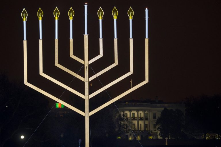 The White House is in the background after the national menorah was lit during a ceremony marking the start of the celebration of Hanukkah, on the Ellipse near the White House in Washington, Tuesday, Dec. 16, 2014. (AP Photo/Cliff Owen)