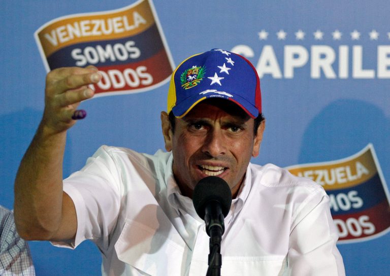 Opposition presidential candidate Henrique Capriles talks to journalists in Caracas, Venezuela, Monday, April 15, 2013. Venezuela's government-friendly electoral council indicated Monday it would quickly certify the presidential victory of Hugo Chavez' hand-picked successor Nicolas Maduro, apparently ignoring opposition demands for a recount in Sunday's tight race. (AP Photo/Fernando Llano)
