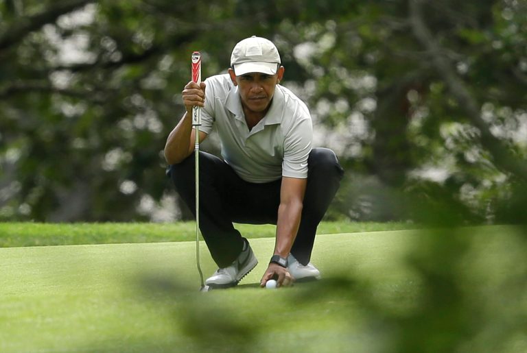 President Barack Obama places his ball on the green before putting while golfing in 2015 at Farm Neck Golf Club, in Oak Bluffs, Mass., on the island of Martha's Vineyard. The first family plans a return this summer. (AP Photo/Steven Senne)