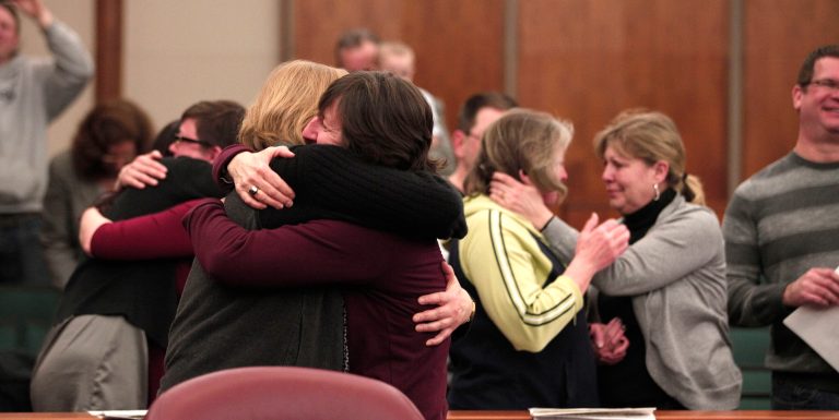 Same-sex couples hug after getting married in a group ceremony. (Bill Pugliano/Getty Images)