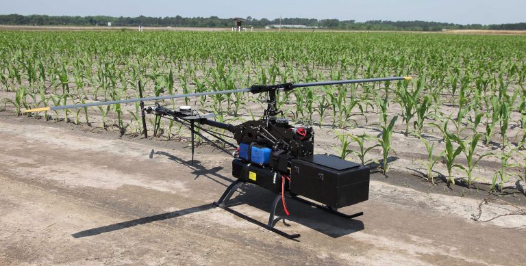 In this Monday, May 19, 2014 photo, an unmanned aerial vehicle equipped with a multi-spectral camera awaits takeoff at the Southeastern Agricultural Center's research farm in Moultrie, Ga. The technology developed by a Georgia consortium is designed to monitor crop vigor, insect infestation and fungal infection for the agriculture industry. (AP Photo/Johnny Clark)