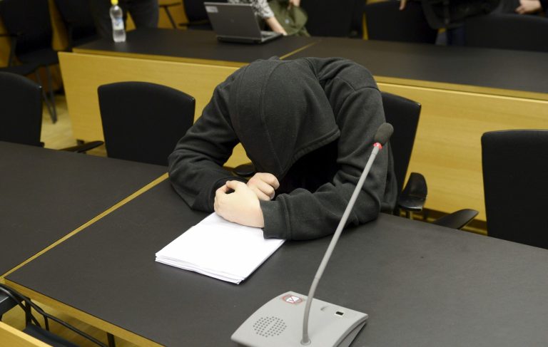 An unidentified man, bows his head, at a court hearing, in Helsinki, Finland, Monday, May 26, 2014. A man and a woman are being tried for planning an attack at the University of Helsinki with the aim of killing several people and for possessing weapons to carry out the slaughter. The case opened Monday at Helsinki District Court against the suspects, who were not named. They were not students at the university. (AP Photo/Lehtikuva, Antti Aimo-Koivisto)  FINLAND OUT